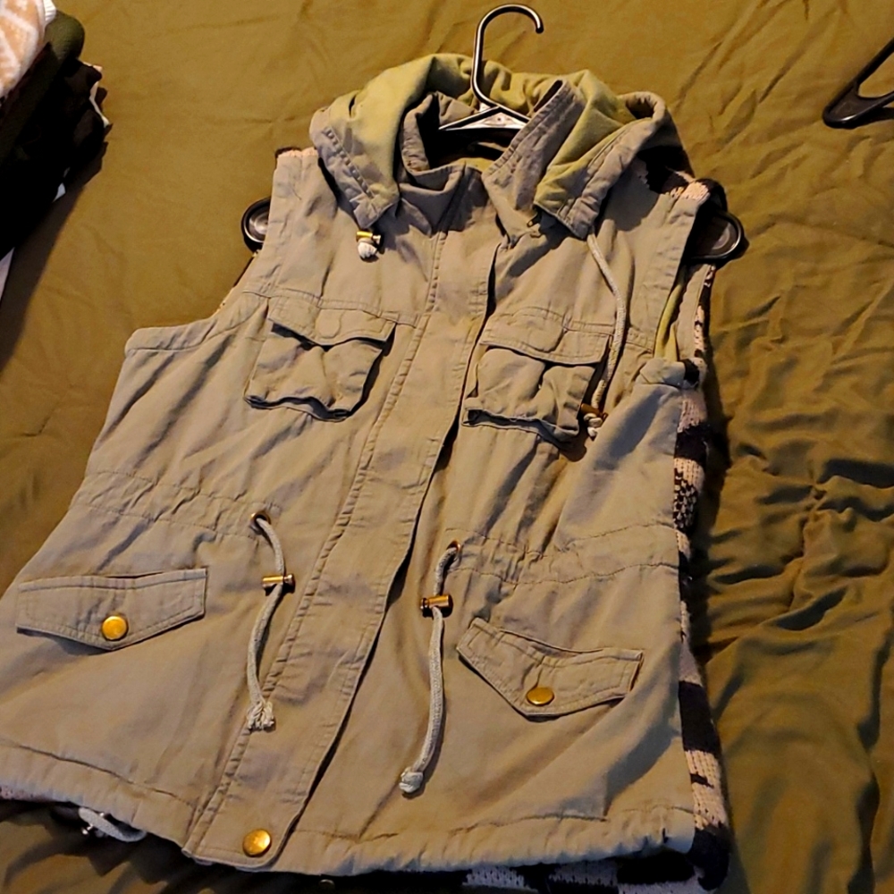 Green bomber vest with Aztec design on back.